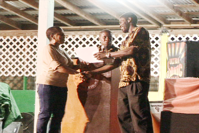 Calvin “Isoursop” Johnson presents cheque to the Nevis Renal Society on behalf of the Isoursop Making a Difference Foundation.